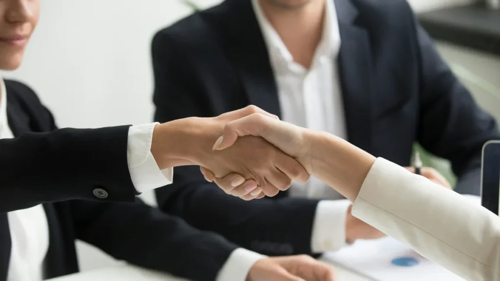 Business handshake in a modern office symbolizing outsourcing digital agency jobs